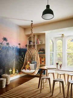 a dining room with a table chairs and a refrigerator