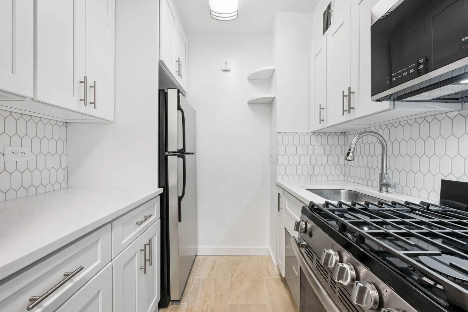 a kitchen with stainless steel appliances a sink and a stove