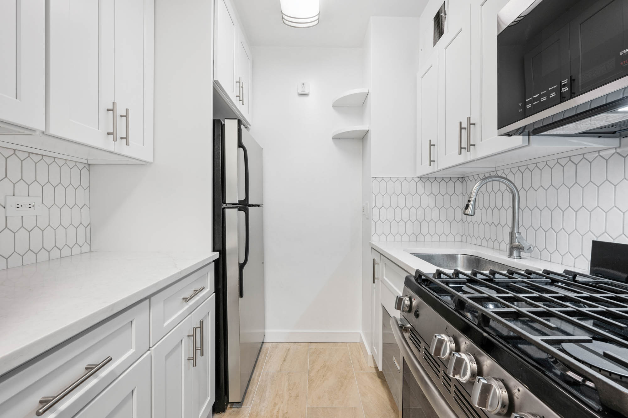 a kitchen with stainless steel appliances a sink and a stove