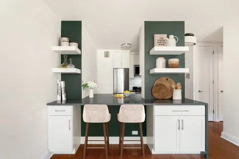 a living room with furniture and kitchen area