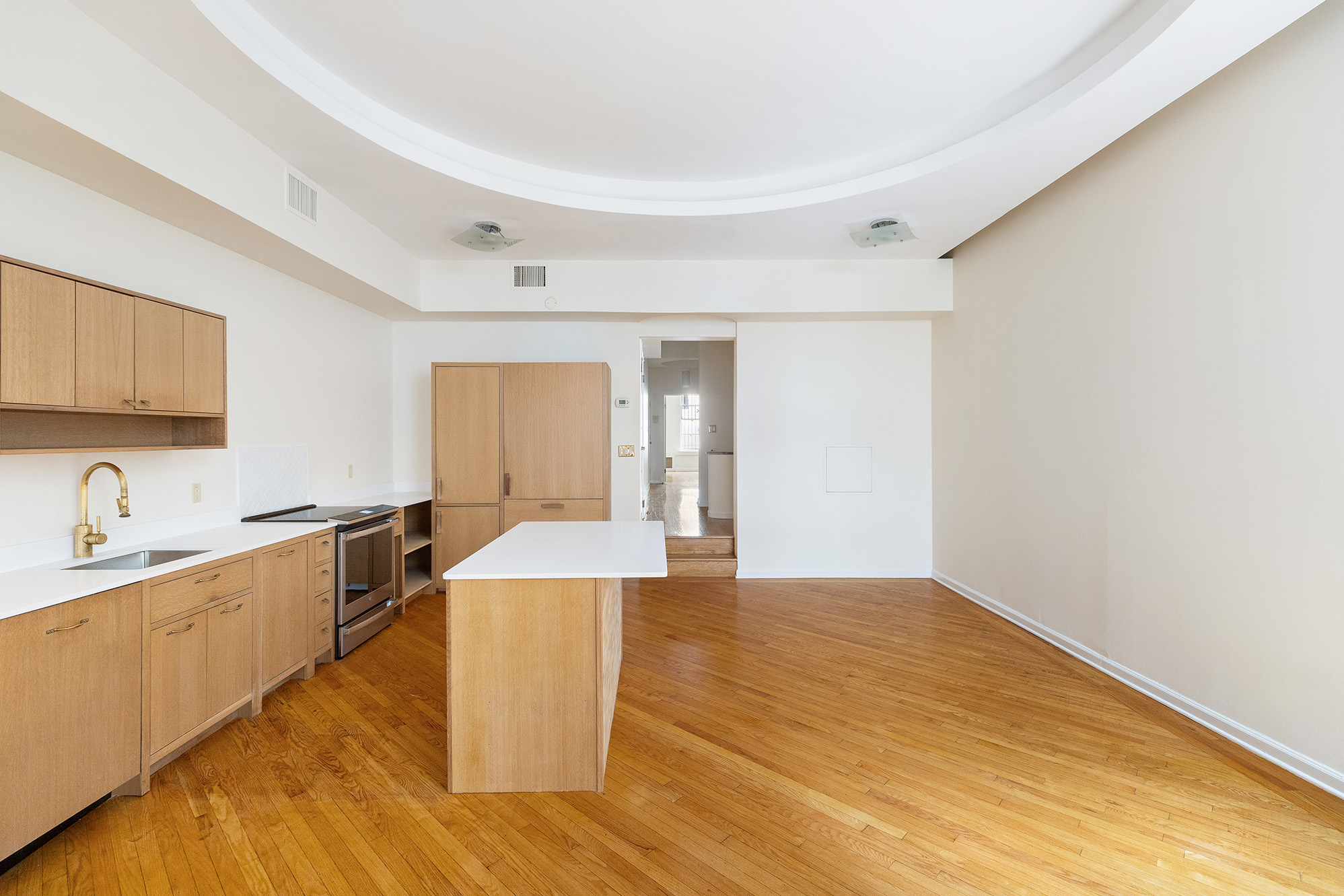 23 East 81st Street, Unit 1 Manhattan, NY 10028 - Photo 16 of 23 a large white kitchen with wooden floor