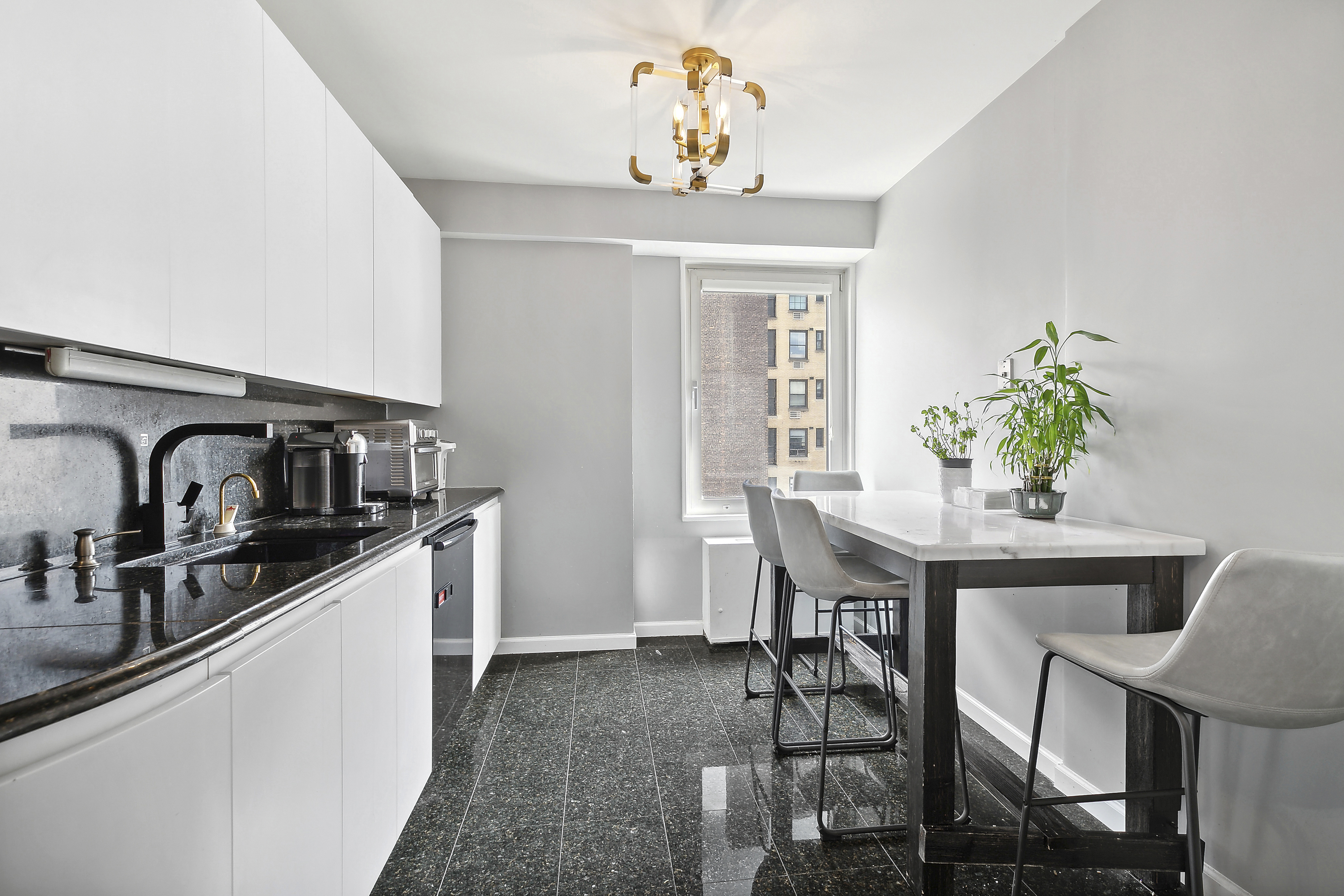 303 East 57th Street, Unit 11L Manhattan, NY 10022 - Photo 9 of 11 a view of a dining room with furniture and chandelier
