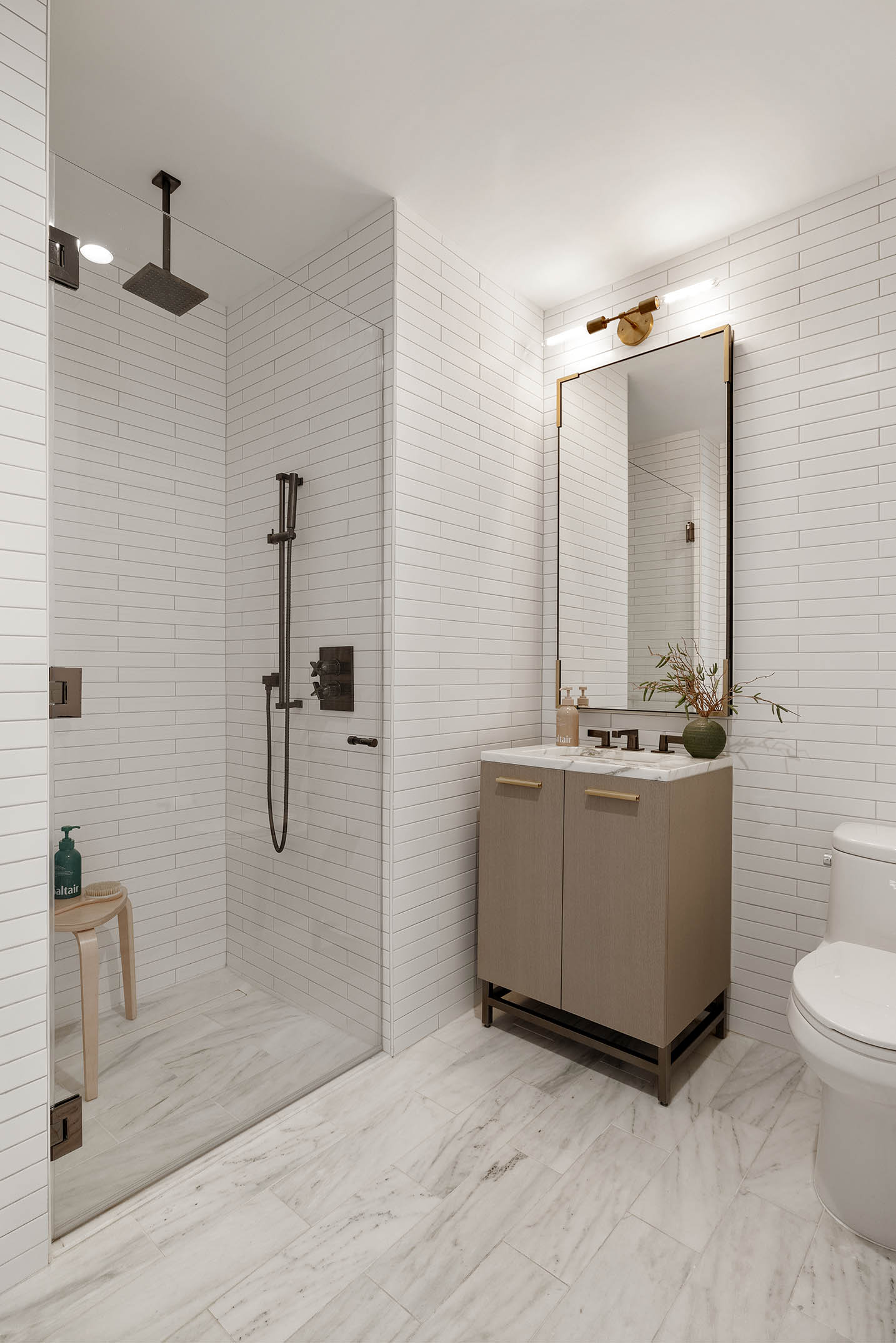 91 Leonard Street, Unit 14A Manhattan, NY 10013 - Photo 18 of 27 a bathroom with a sink a toilet and mirror