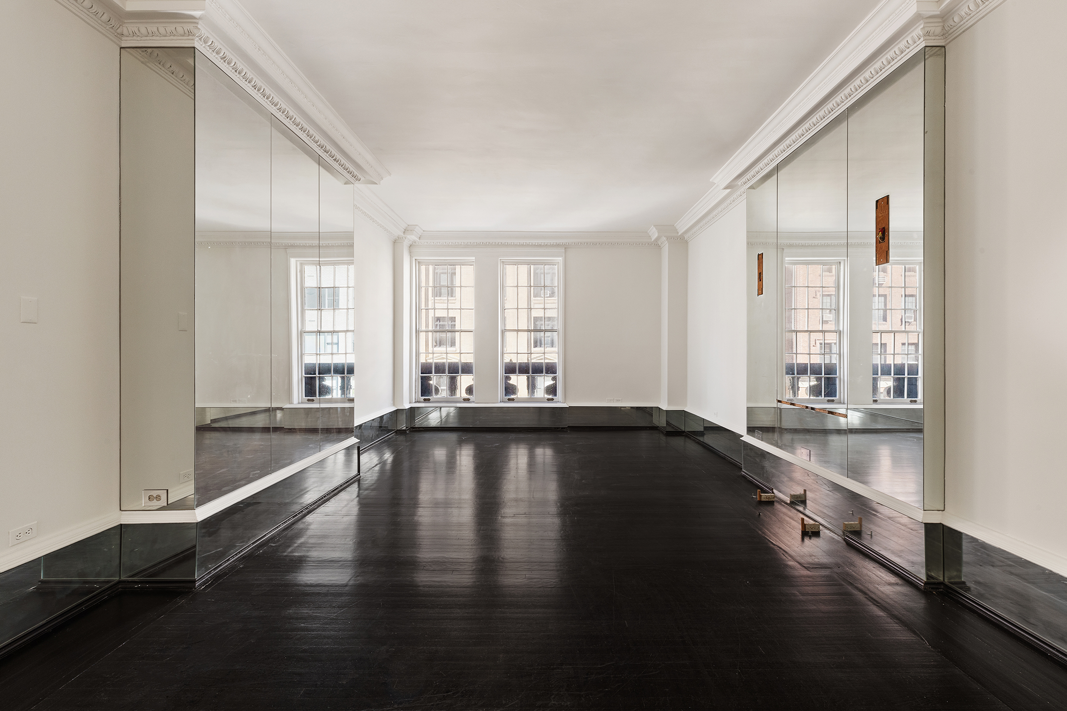 45 East 66th Street, Unit 4NW Manhattan, NY 10065 - Photo 12 of 29 a view of empty room with wooden floor and fan
