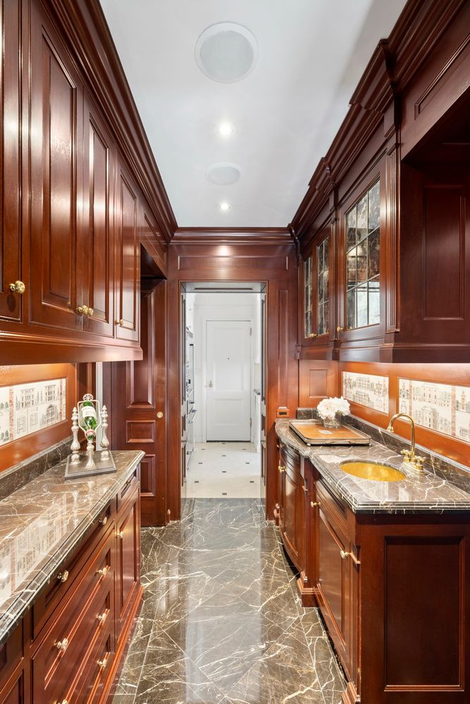 875 5th Avenue, Unit 18A Manhattan, NY 10065 - Photo 12 of 14 a kitchen with stainless steel appliances granite countertop a sink stove and cabinets