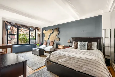 a bedroom with a large bed and a large window