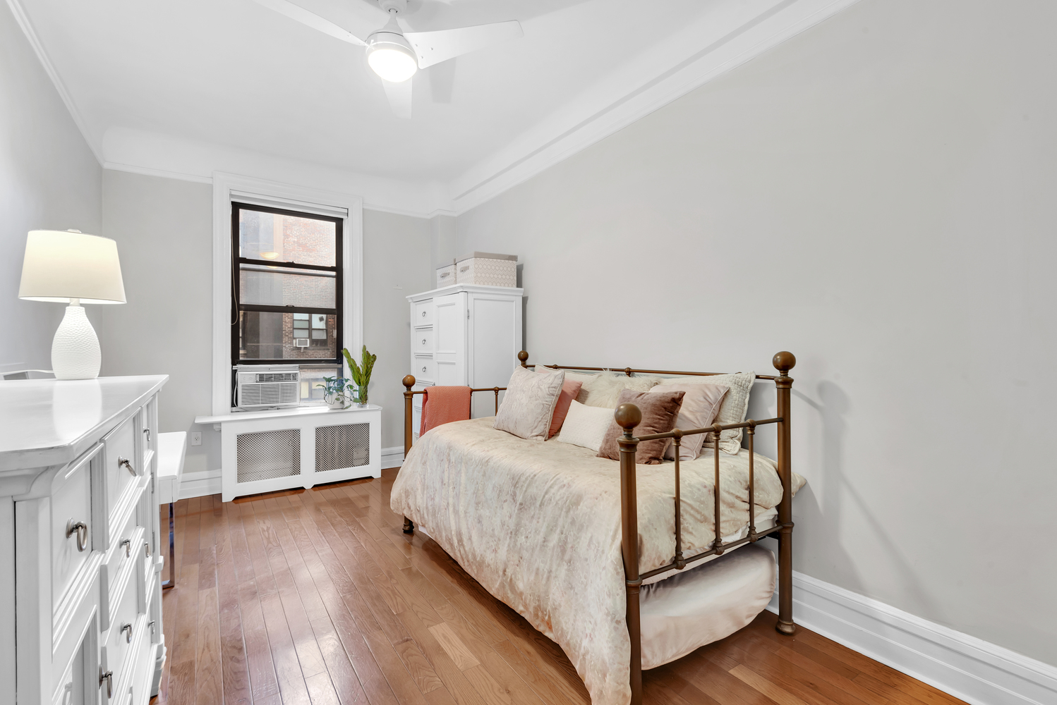 215 West 98th Street, Unit 8F Manhattan, NY 10025 - Photo 9 of 16 a bedroom with a bed and a wooden floor