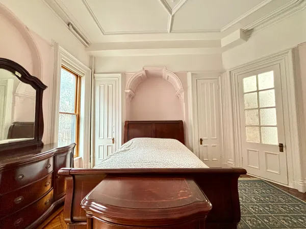 a room with a bed and windows