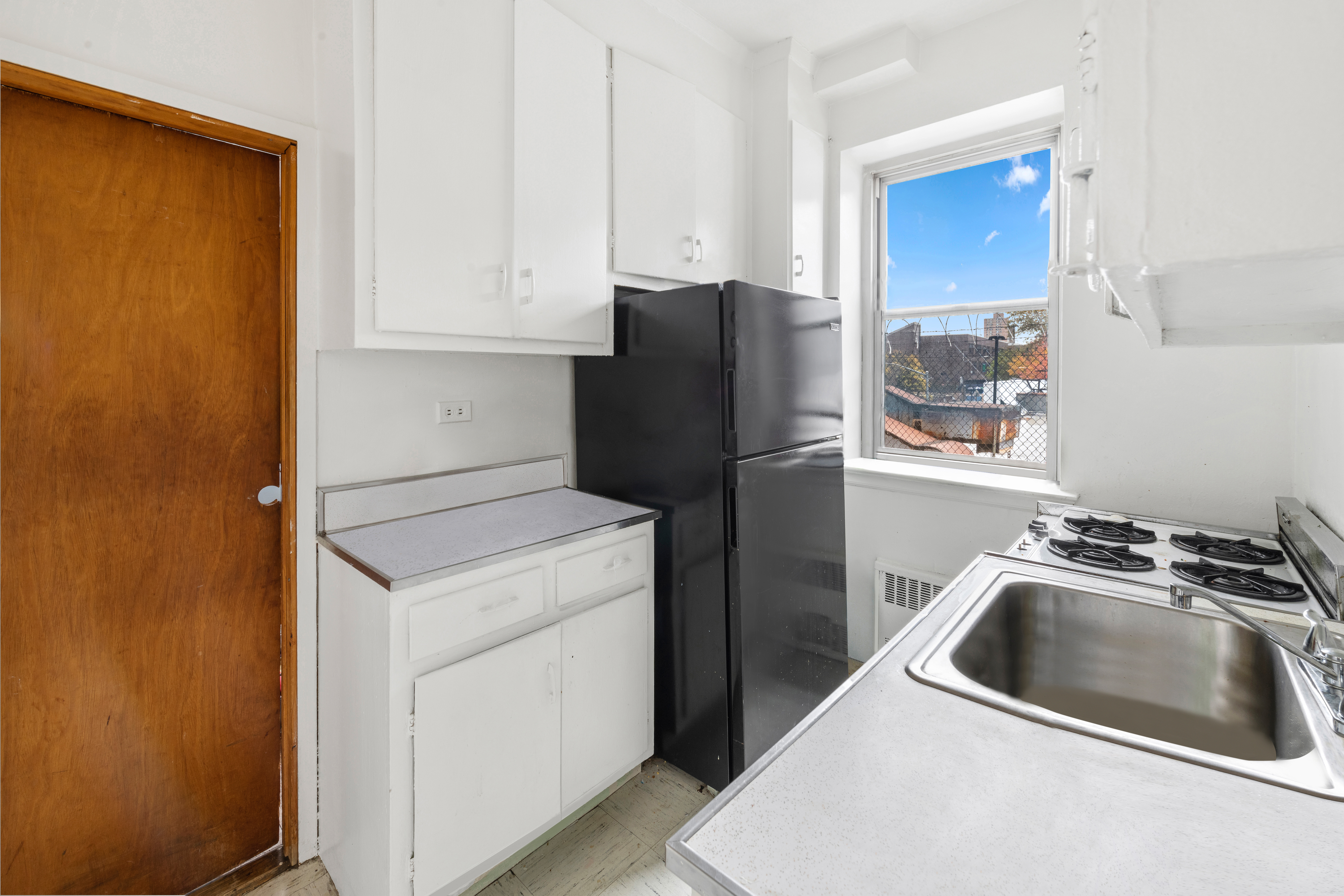 800 Grand Concourse, Unit GMS Bronx, NY 10451 - Photo 3 of 13 a kitchen with a refrigerator sink and cabinets