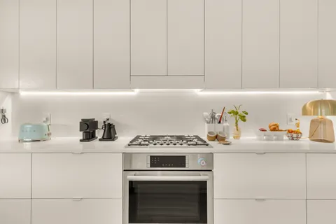 a kitchen with a sink stove and cabinets
