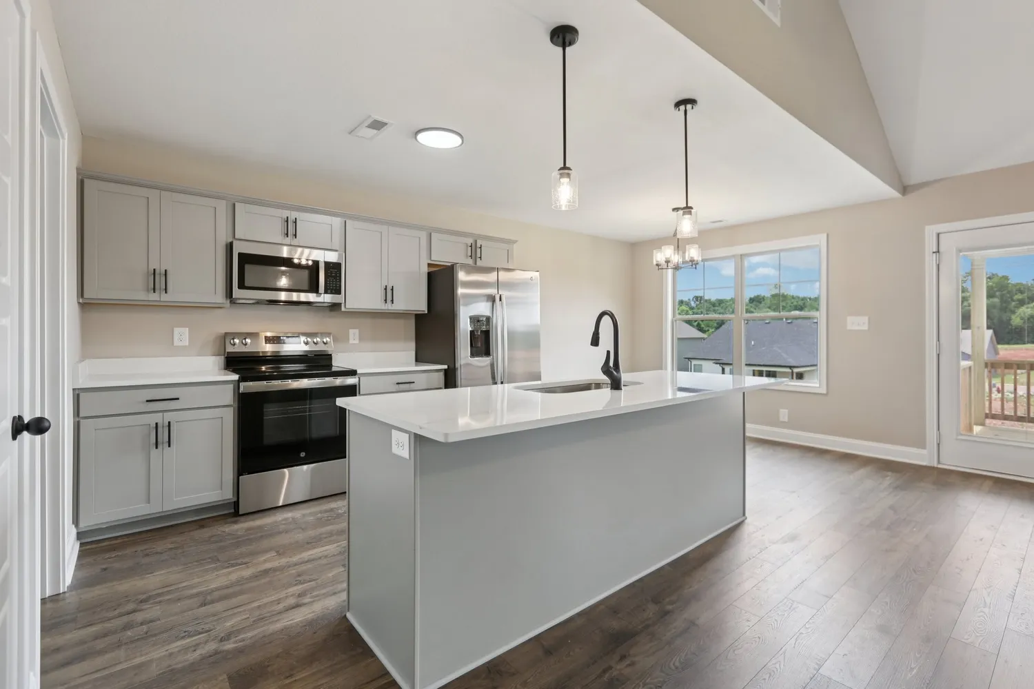 a kitchen with kitchen island white cabinets and stainless steel appliances