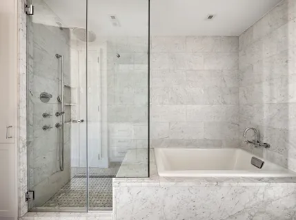 a bathroom with a bathtub and shower