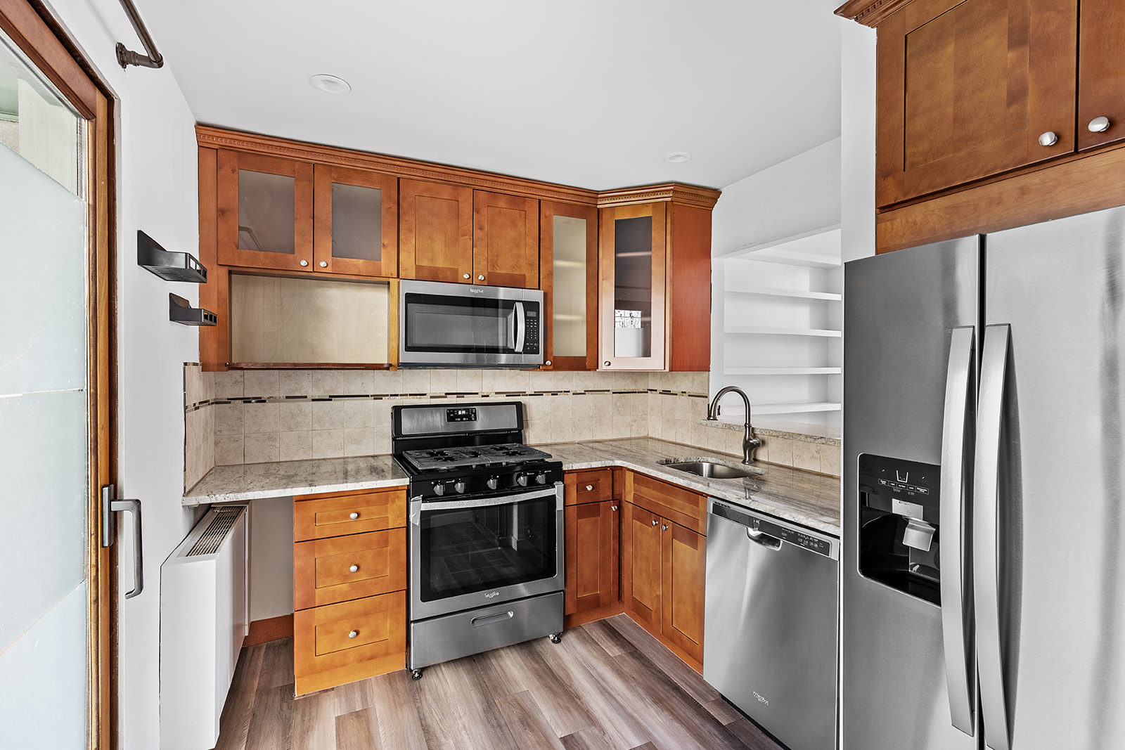 126 Waverly Place, Unit 2F Manhattan, NY 10011 - Photo 3 of 11 a kitchen with stainless steel appliances a stove a sink and a refrigerator