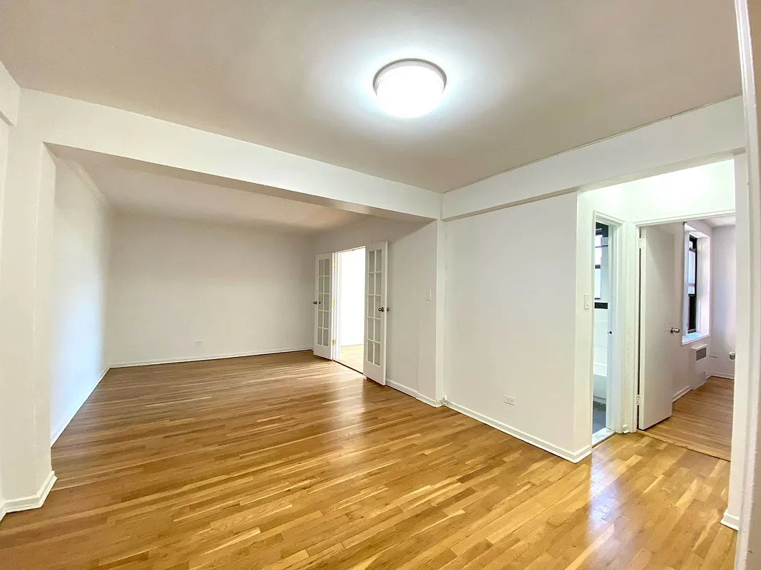 a view of an empty room and wooden floor