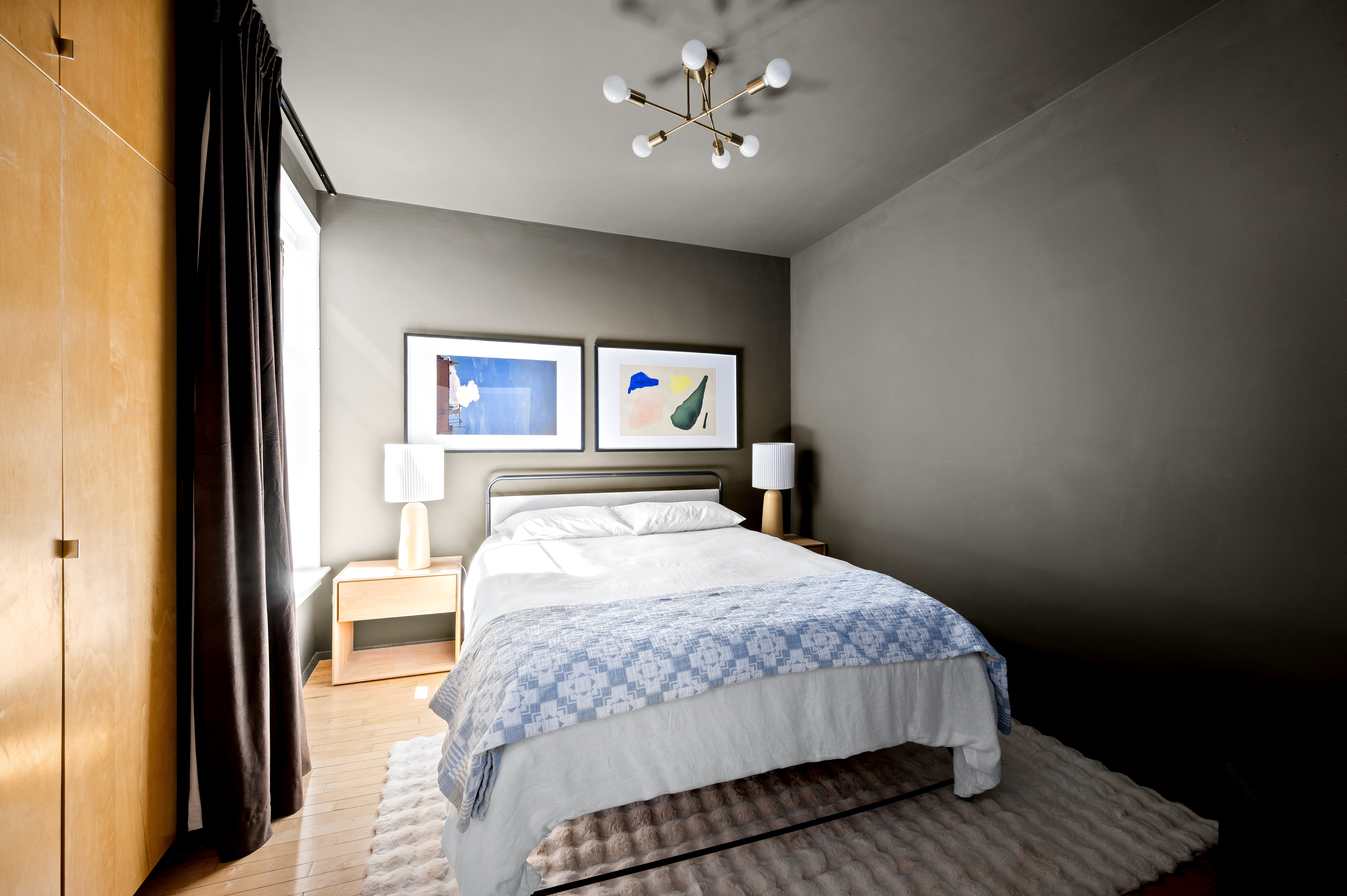 206 West 85th Street, Unit 5 Manhattan, NY 10024 - Photo 4 of 15 a bedroom with a large bed and a chandelier