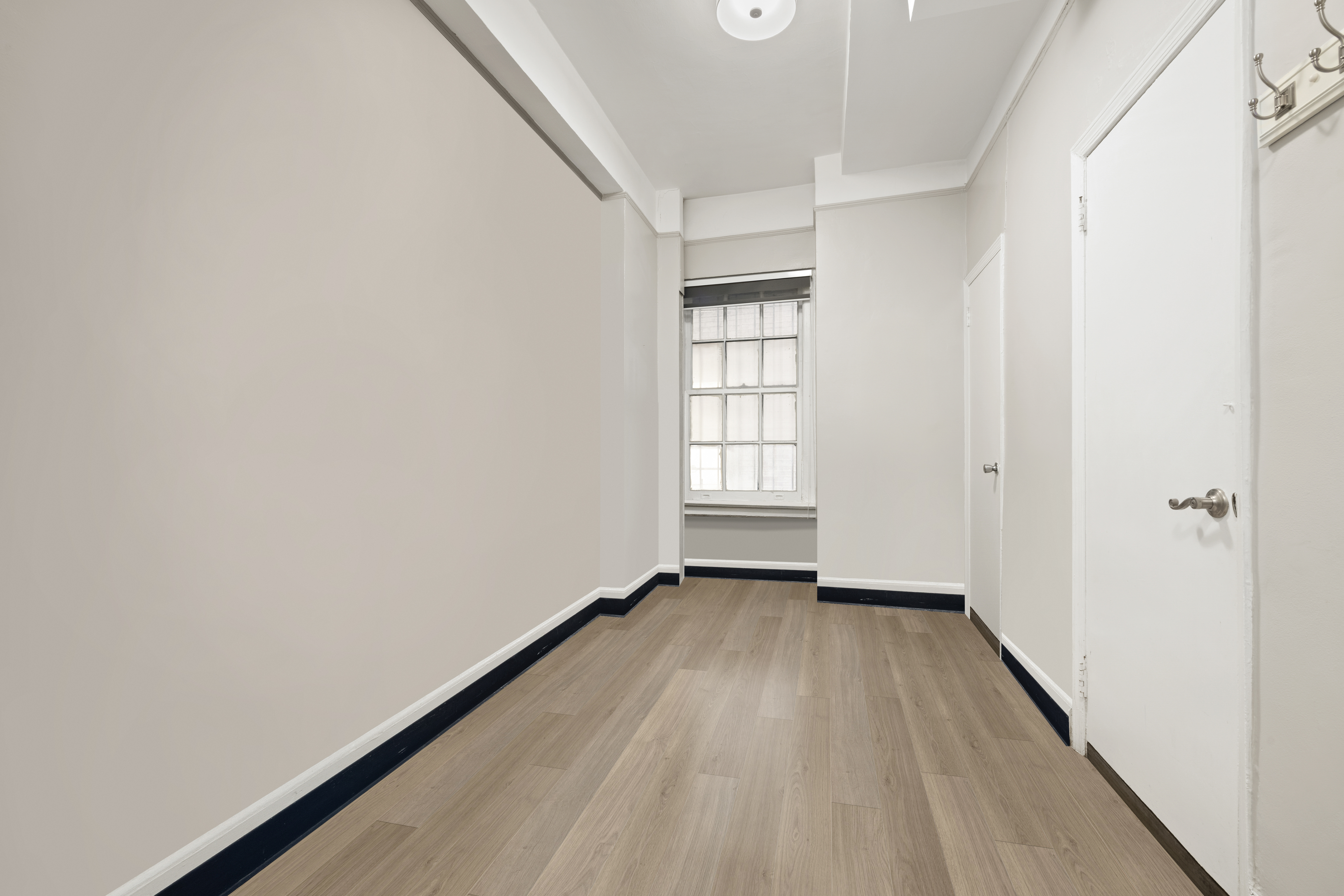 162 East 80th Street, Unit 1B Manhattan, NY 10075 - Photo 7 of 10 a view of an empty room and a window