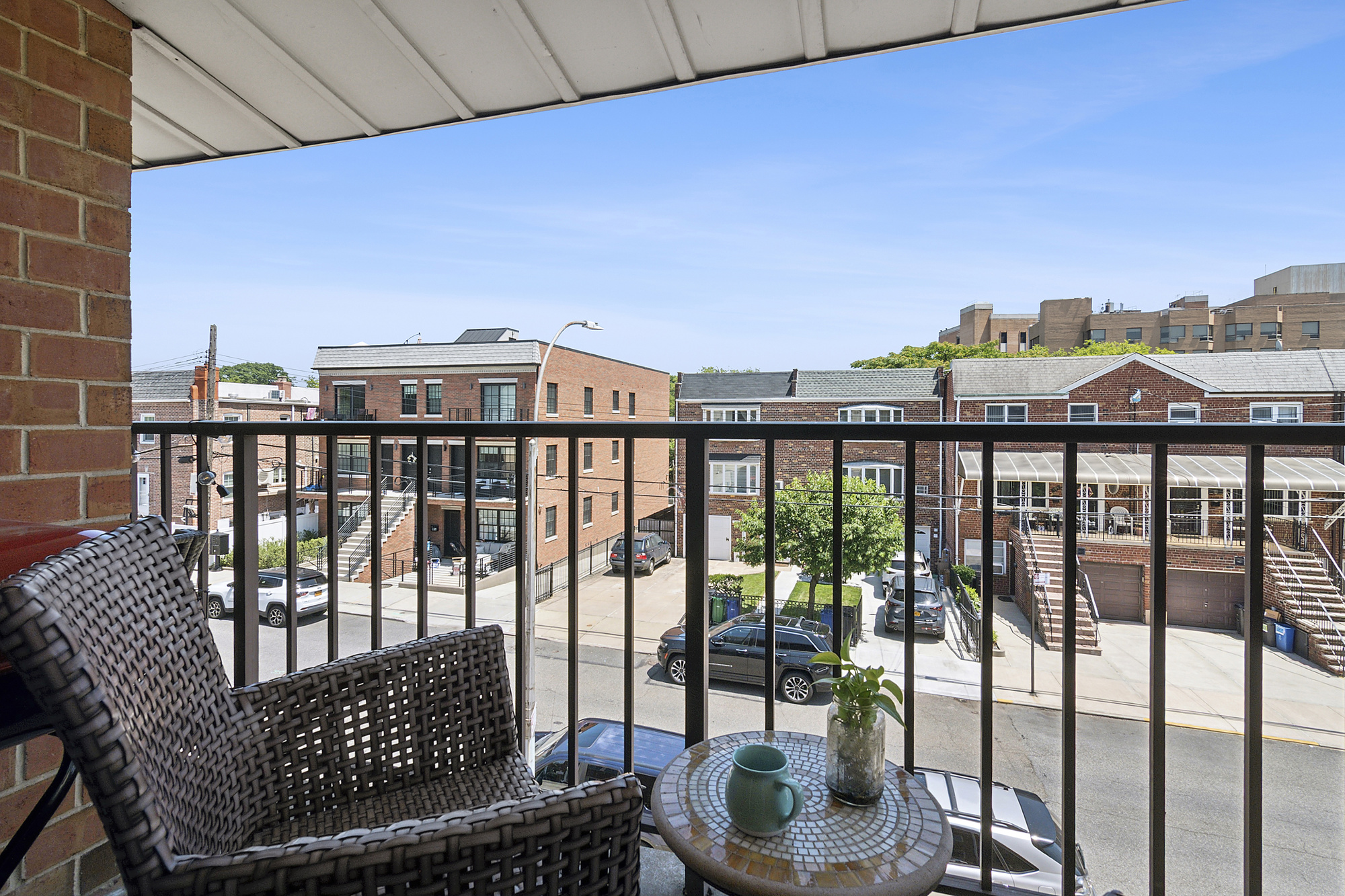 a view of a balcony with chair and a floor to ceiling window