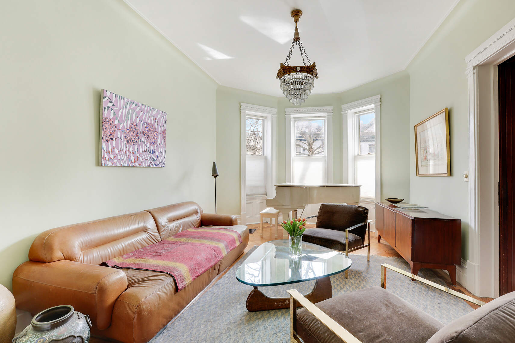 261 Fenimore Street Brooklyn, NY 11225 - Photo 6 of 21 a living room with furniture a fireplace and a chandelier