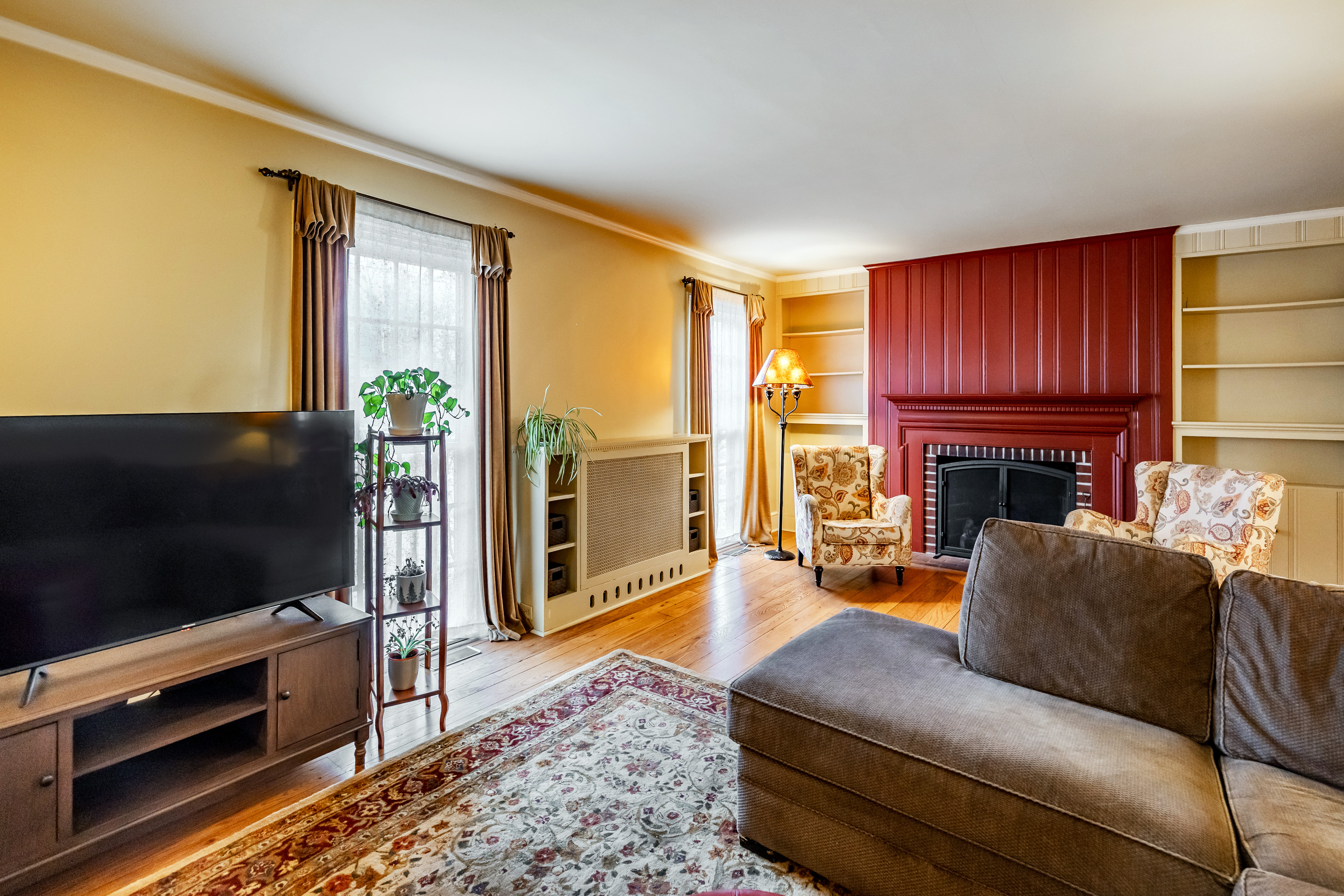 14 Decatur Road Havertown, PA 19083 - Photo 10 of 43 a living room with furniture a flat screen tv and a fireplace