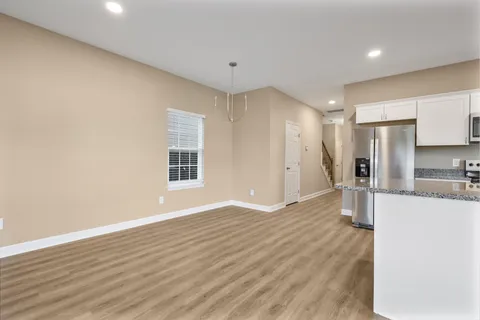 a view of a kitchen with a sink and a refrigerator