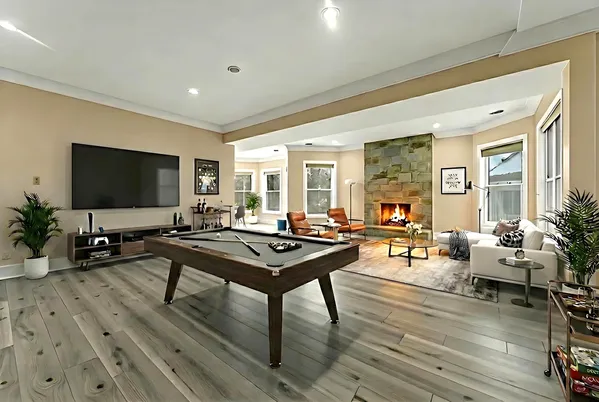 a living room with furniture a wooden floor and a flat screen tv