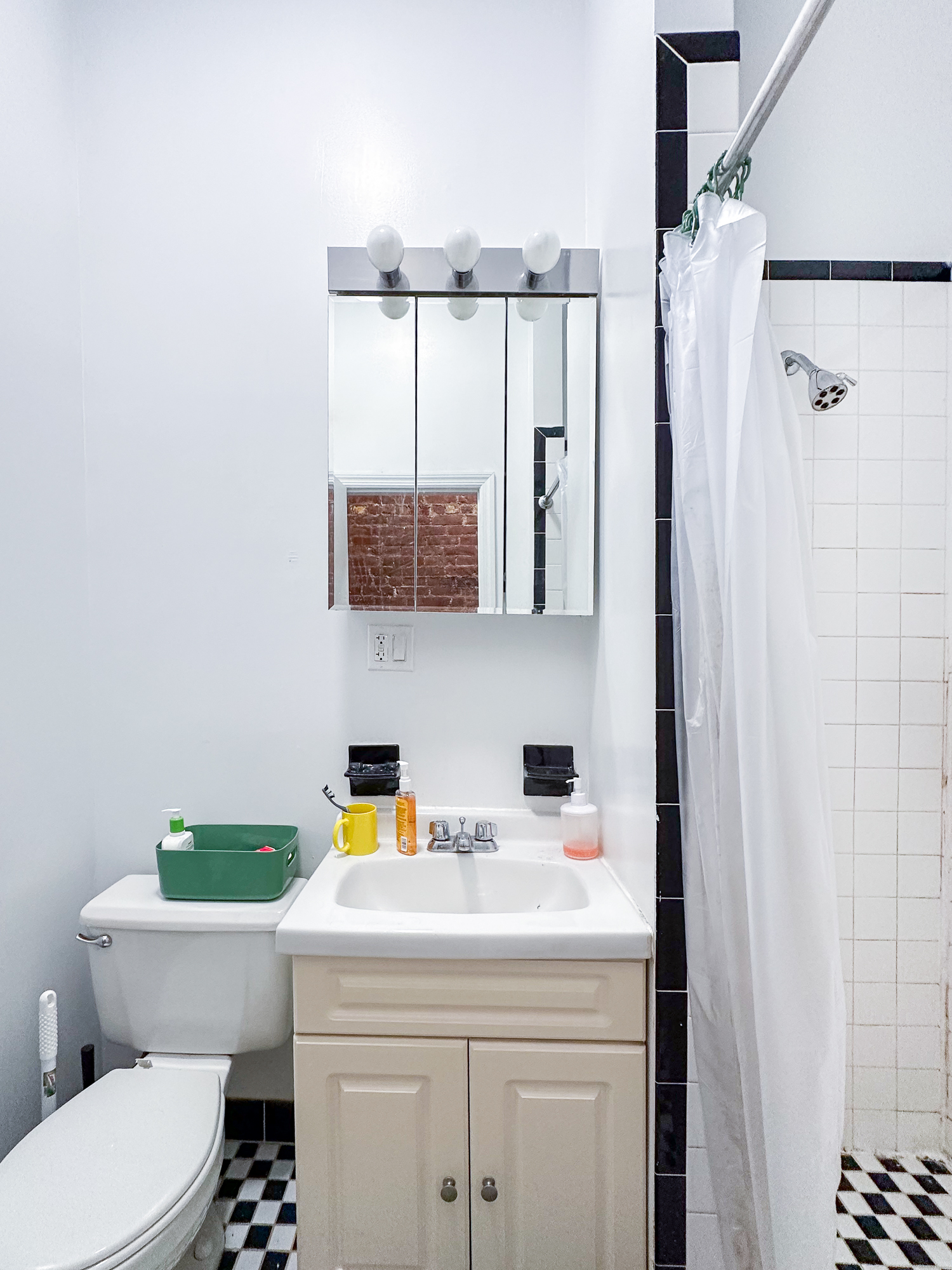 213 East 5th Street, Unit 1 Manhattan, NY 10003 - Photo 7 of 18 a bathroom with a sink a toilet and shower curtain