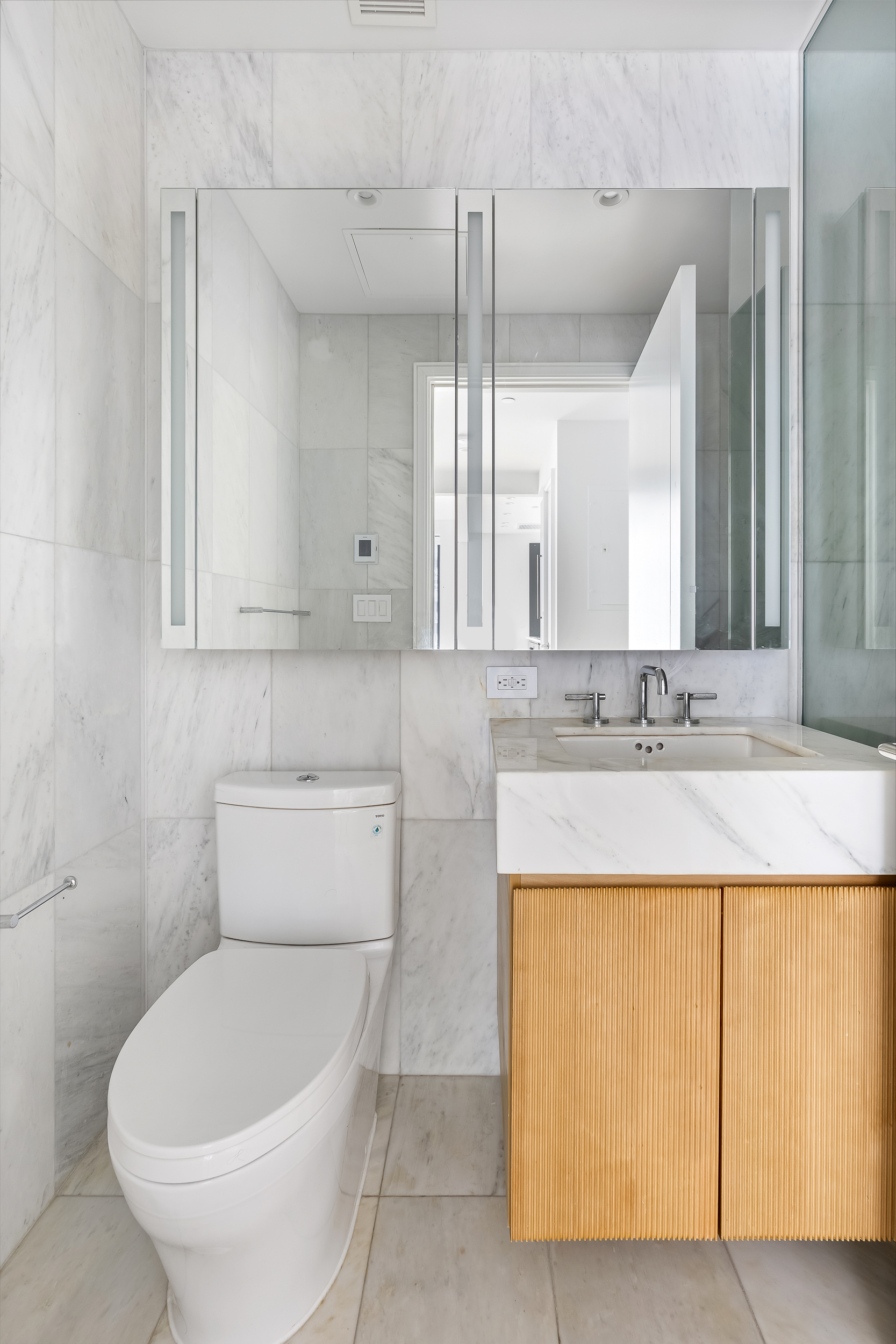 300 West 30th Street, Unit 7F Manhattan, NY 10001 - Photo 4 of 11 a bathroom with a toilet sink and mirror