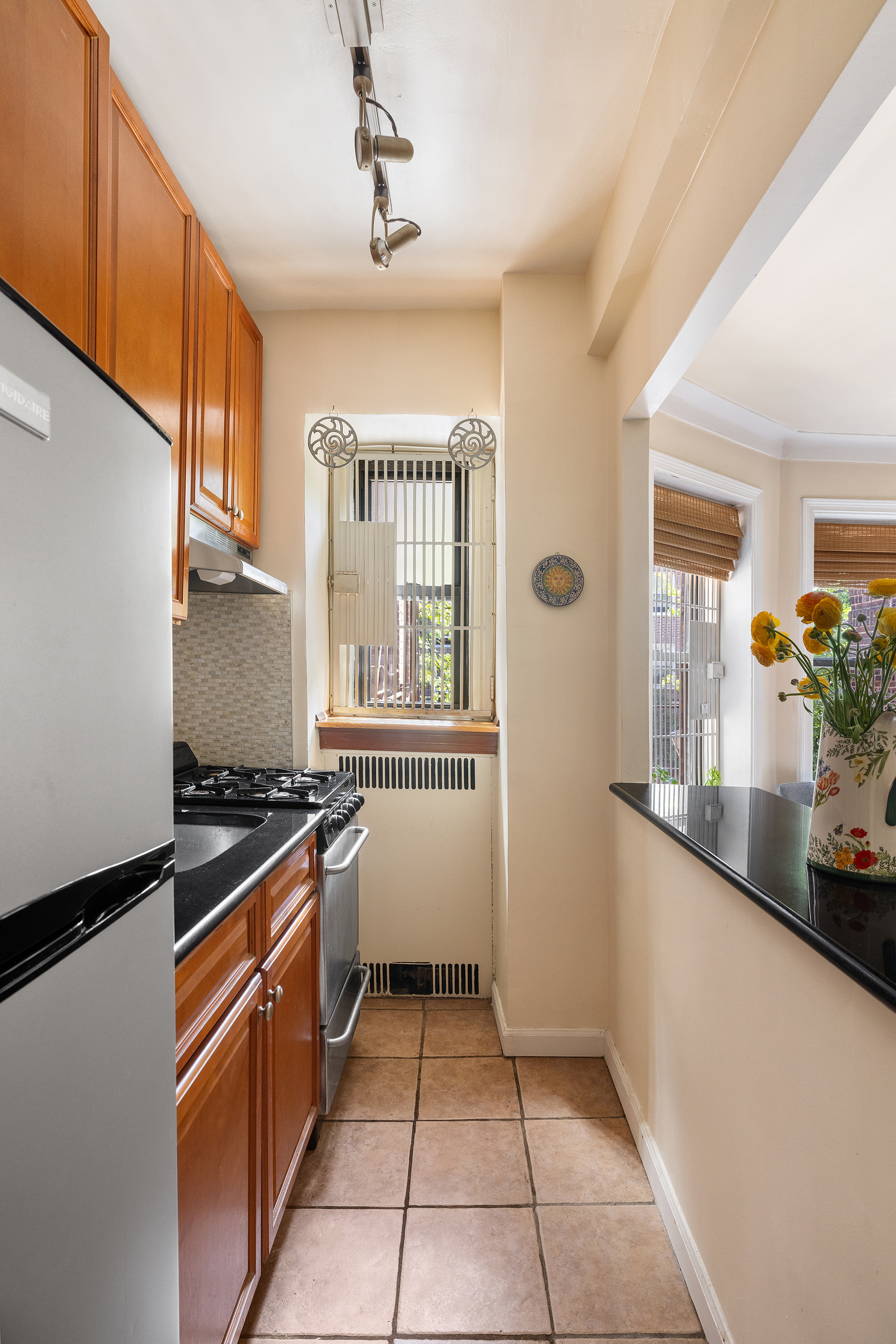 34-24 82nd Street, Unit 2B Queens, NY 11372 - Photo 4 of 8 a kitchen with stainless steel appliances granite countertop a stove a sink and a refrigerator
