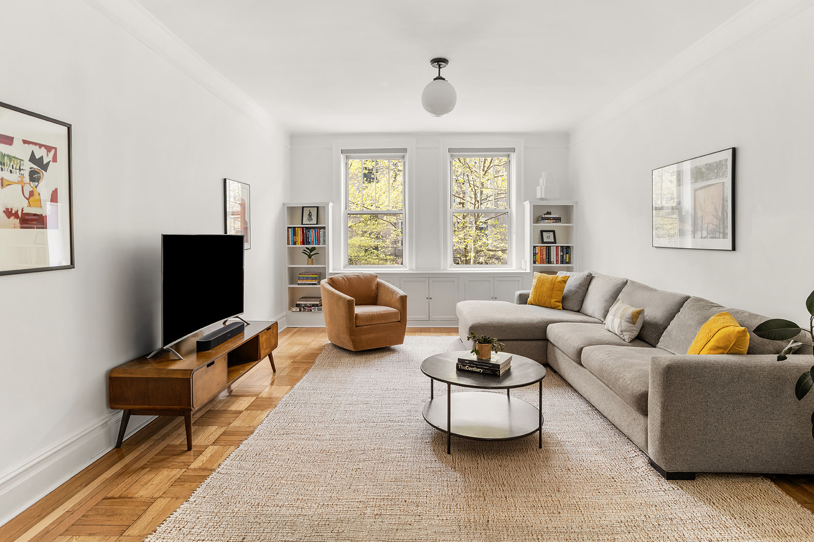 35-47 80th Street, Unit 21 Queens, NY 11372 - Photo 1 of 14 a living room with furniture and a flat screen tv