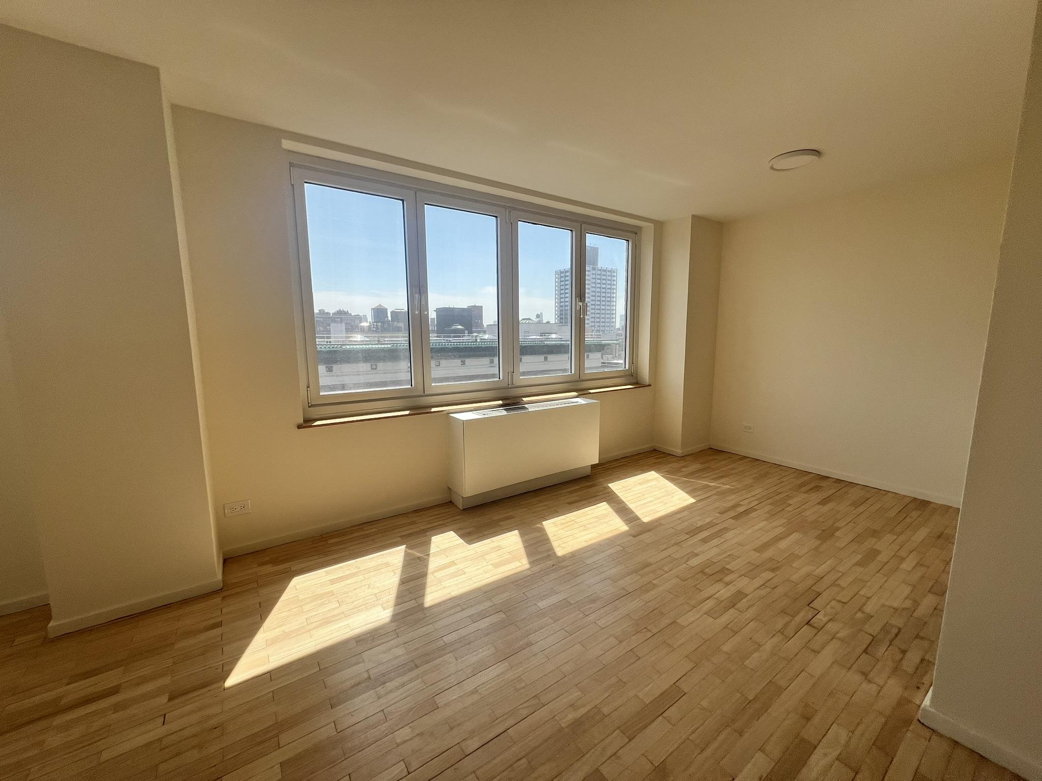 250 West 90th Street, Unit PH2F Manhattan, NY 10024 - Photo 2 of 21 wooden floor in an empty room with a window