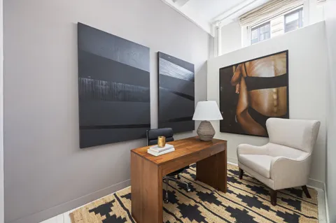 a living room with furniture and a mirror