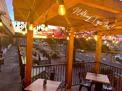 a view of a chairs and table in the balcony