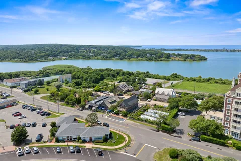 an aerial view of a city with lots of residential buildings lake and ocean view