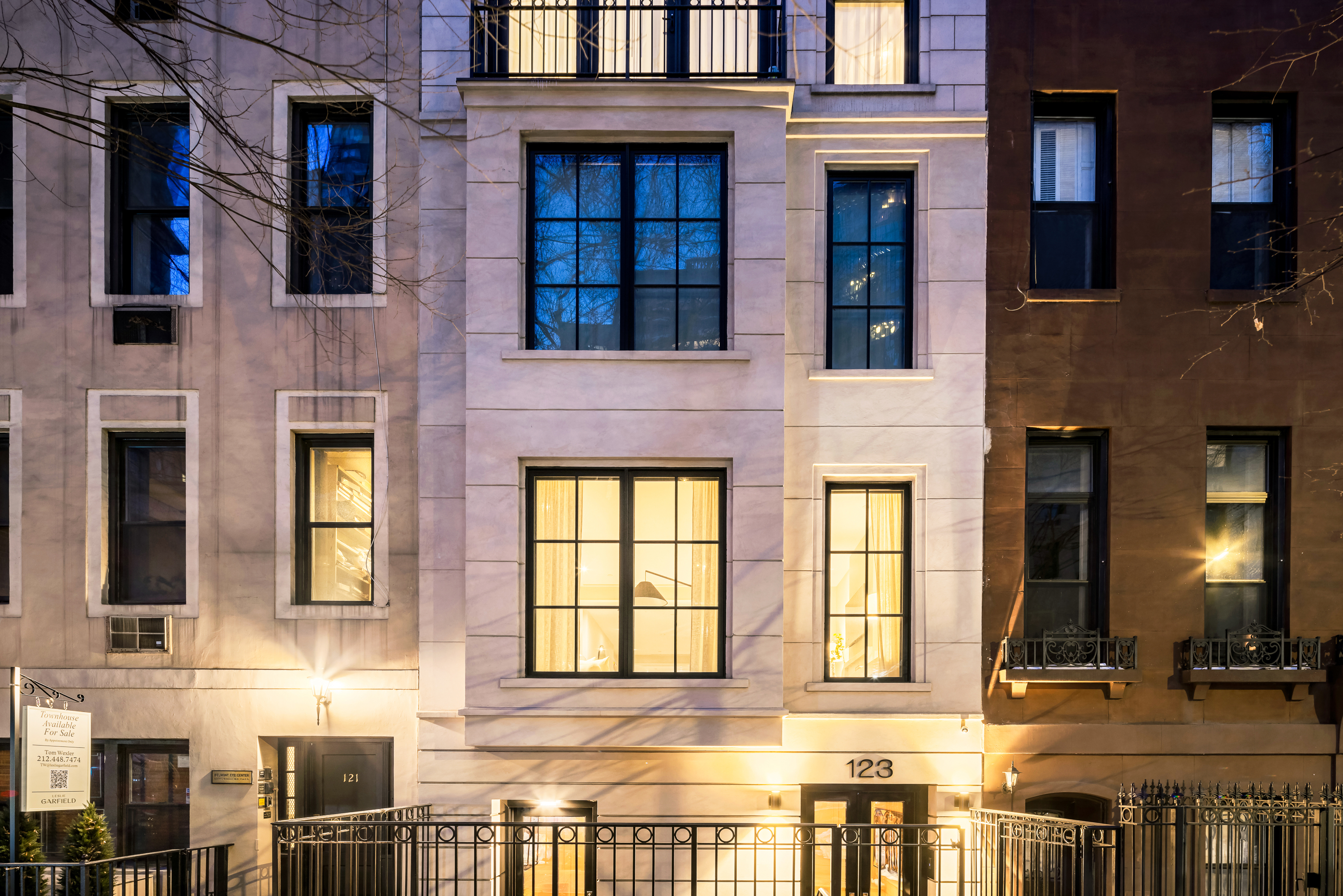123 East 61st Street Manhattan, NY 10065 - Photo 30 of 31 a front view of a building with a lot of windows and plants