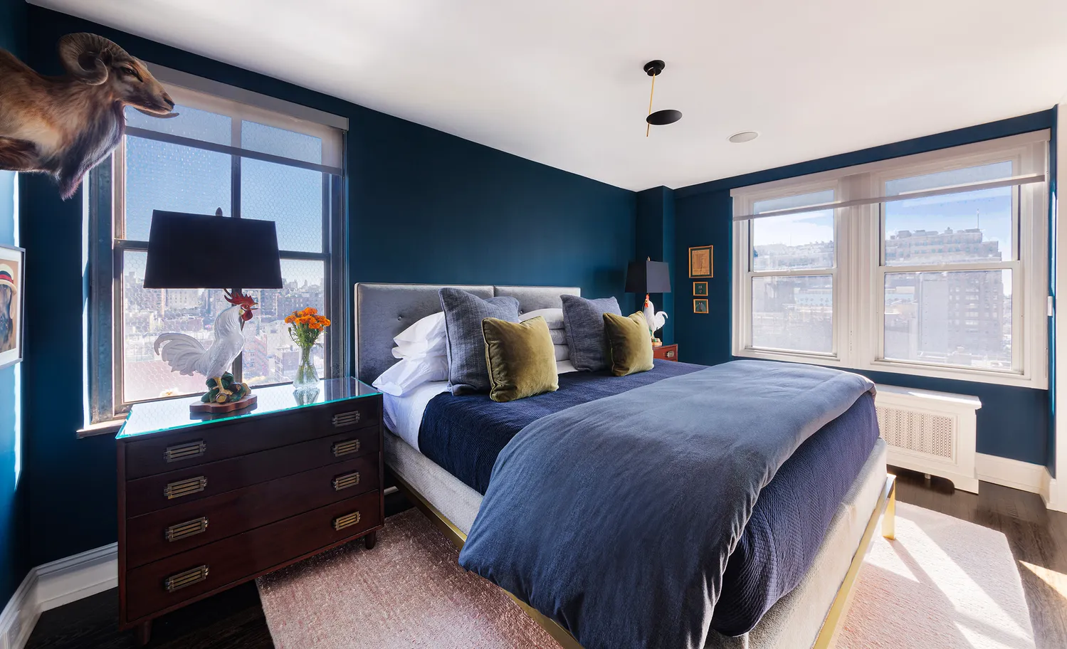 a bedroom with a bed and a flat tv screen on dresser