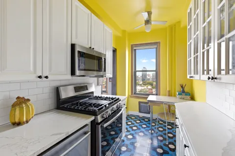 a kitchen with stainless steel appliances a stove a sink and a microwave