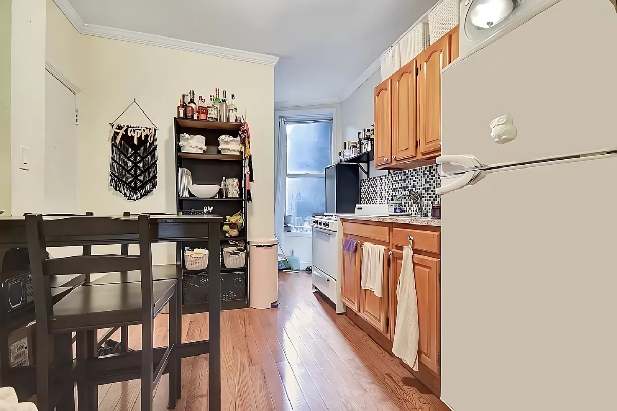 1273 1st Avenue, Unit 8 Manhattan, NY 10065 - Photo 2 of 6 a hallway with a wooden floor a rug and a painting on the wall