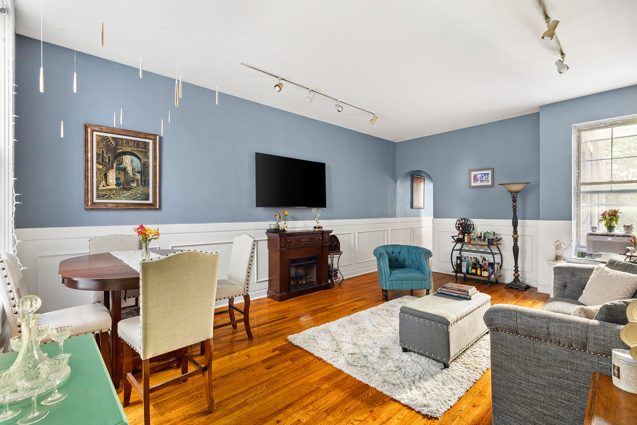 175 East 93rd Street, Unit 3B Manhattan, NY 10128 - Photo 1 of 12 a living room with furniture and a flat screen tv
