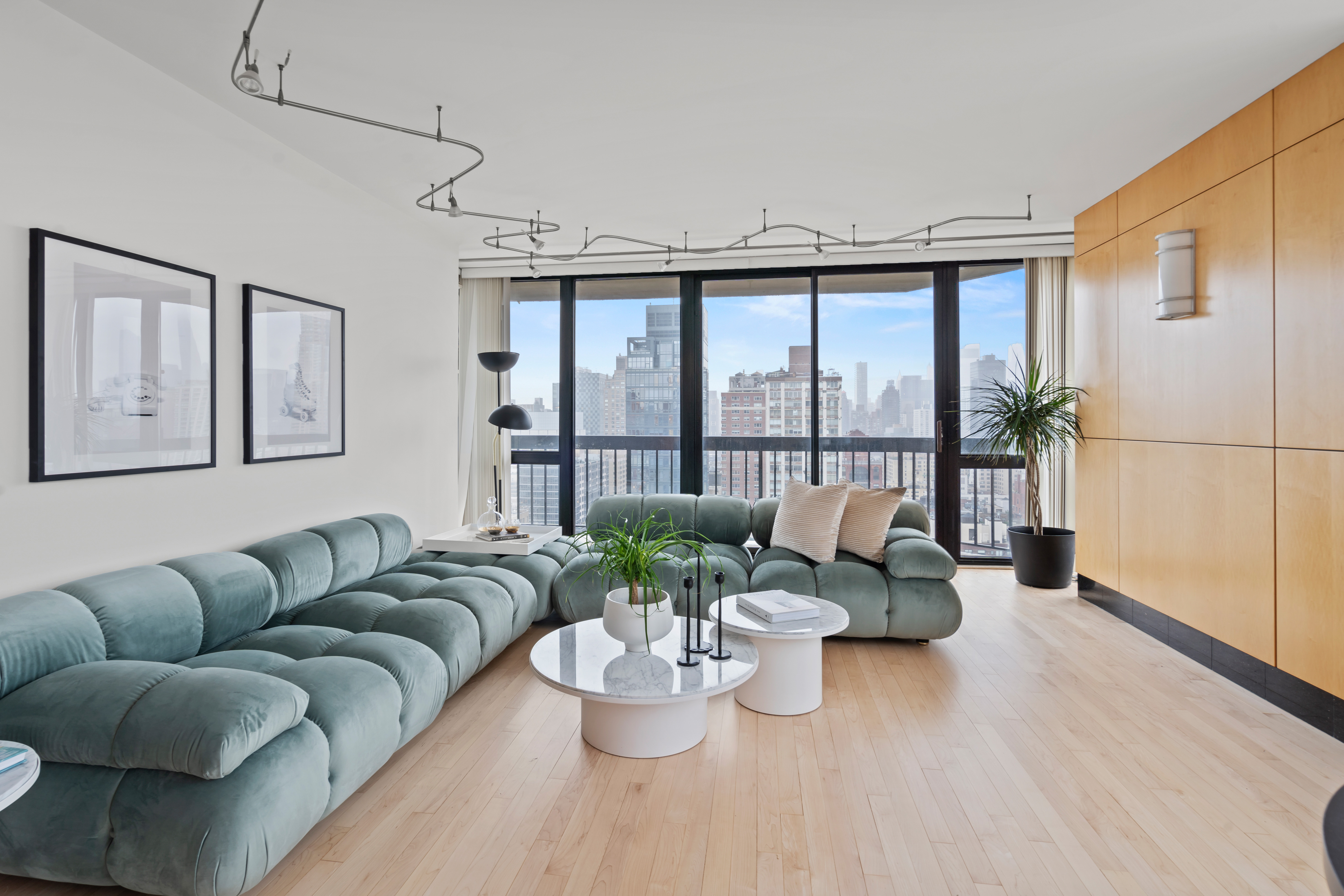 330 East 75th Street, Unit 32A Manhattan, NY 10021 - Photo 2 of 17 a living room with furniture and a large window