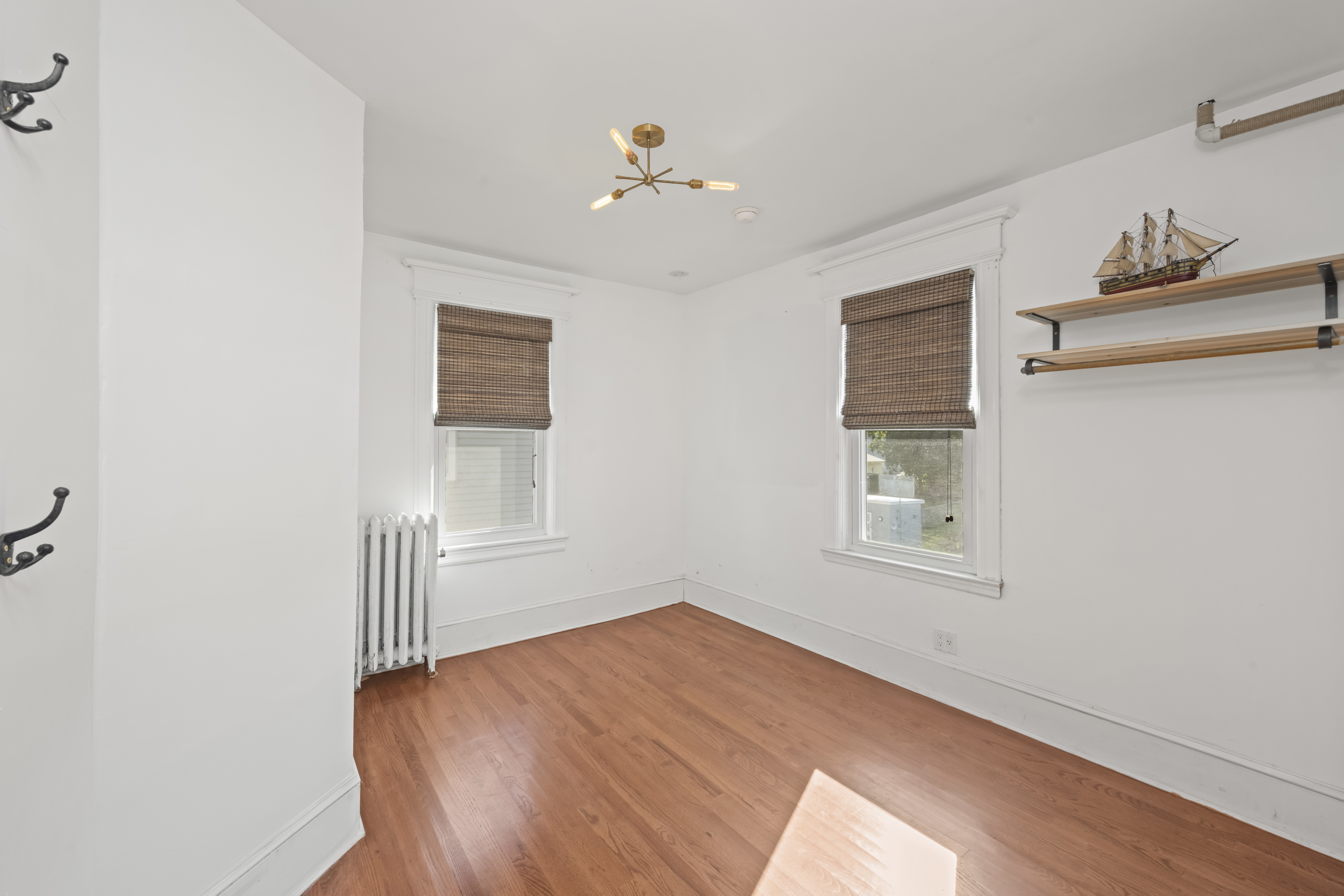 704 Delafield Avenue Staten Island, NY 10310 - Photo 18 of 35 wooden floor in an empty room with a window