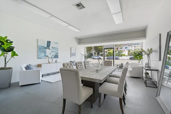 a living room with furniture and a floor to ceiling window