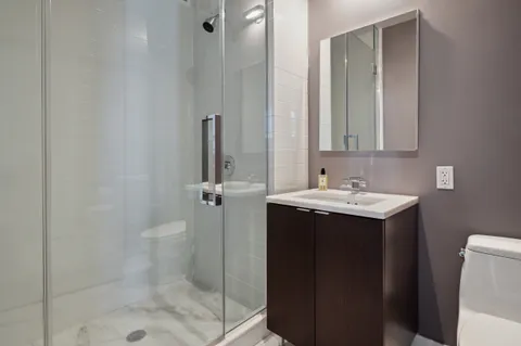 a bathroom with a sink toilet and shower