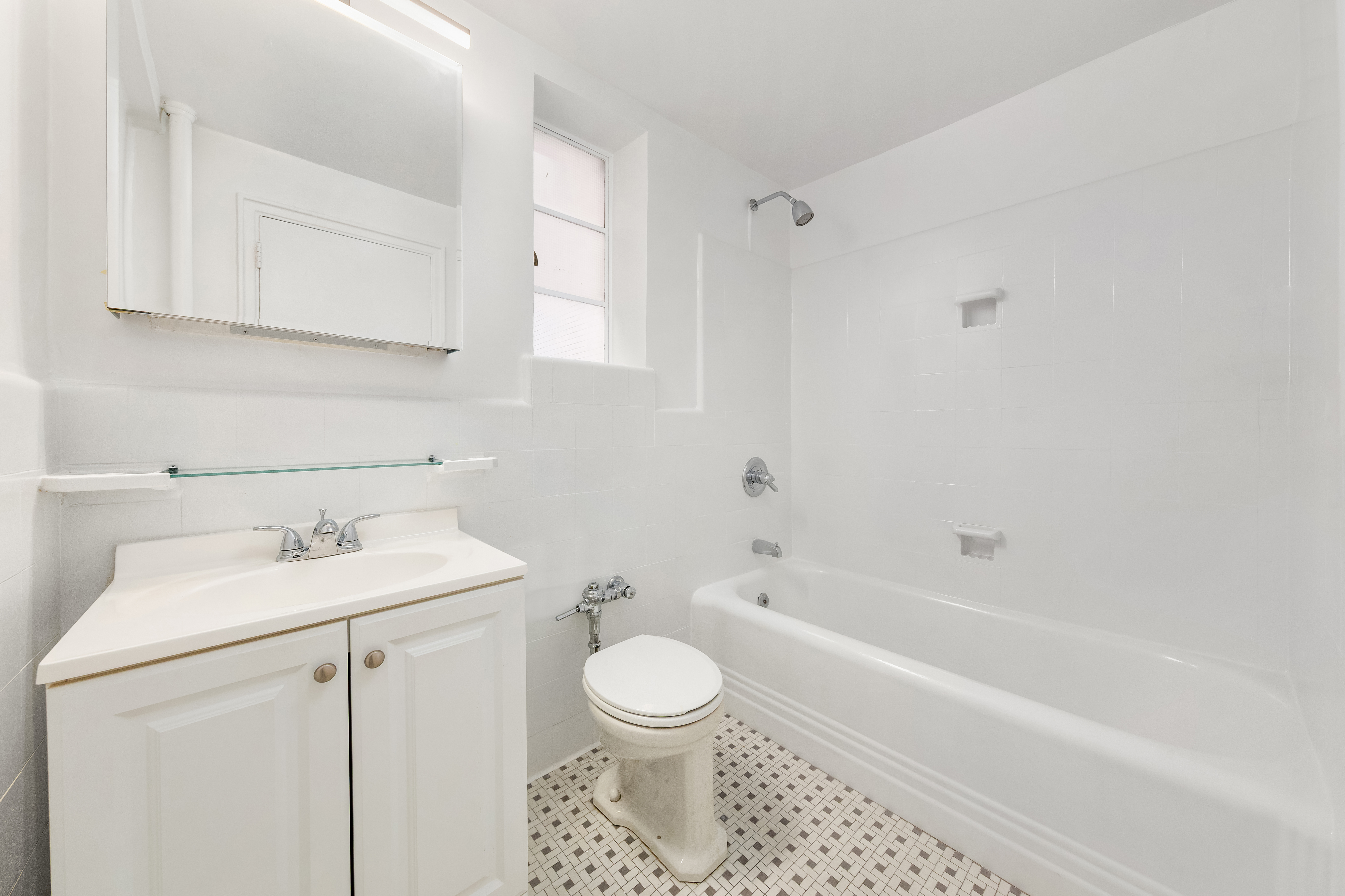 110 East 87th Street, Unit 5C Manhattan, NY 10128 - Photo 12 of 13 a bathroom with a sink toilet and vanity