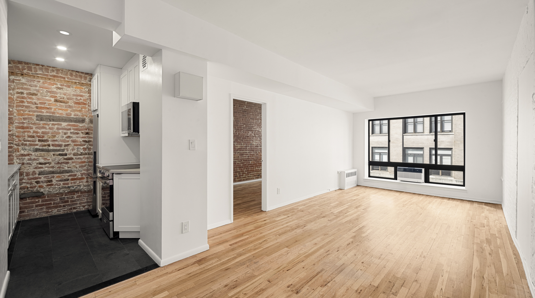 23 East 10th Street, Unit 5A Manhattan, NY 10003 - Photo 1 of 9 wooden floor in an empty room with a window