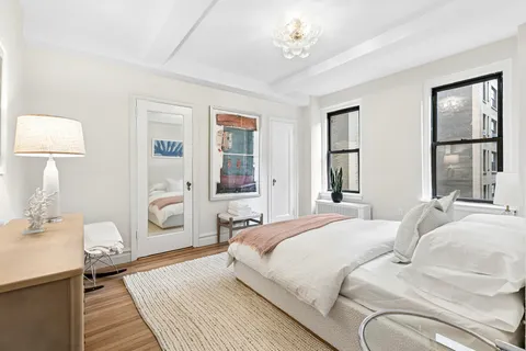 a bedroom with a bed and a chandelier