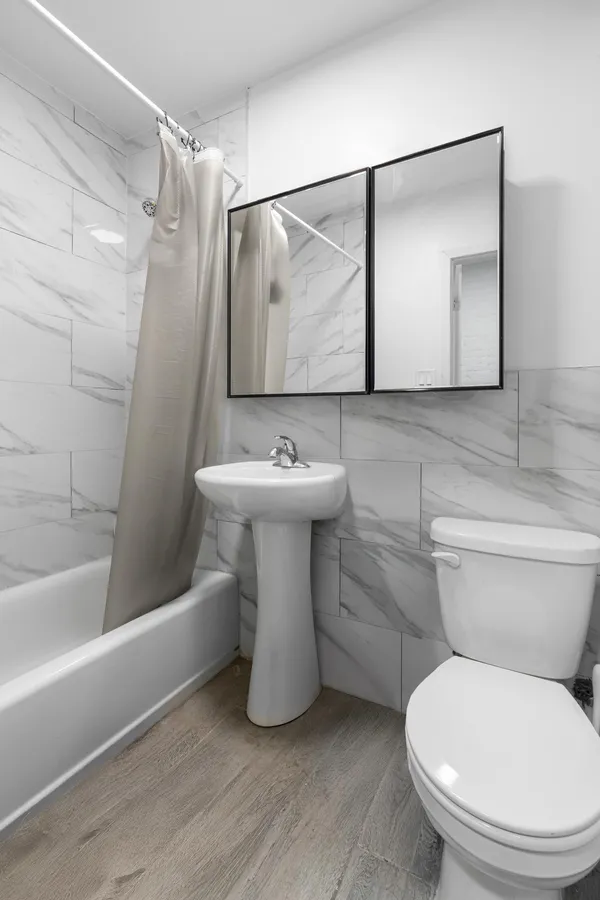 a bathroom with a sink toilet and shower