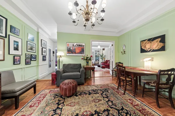 a living room with furniture and a chandelier