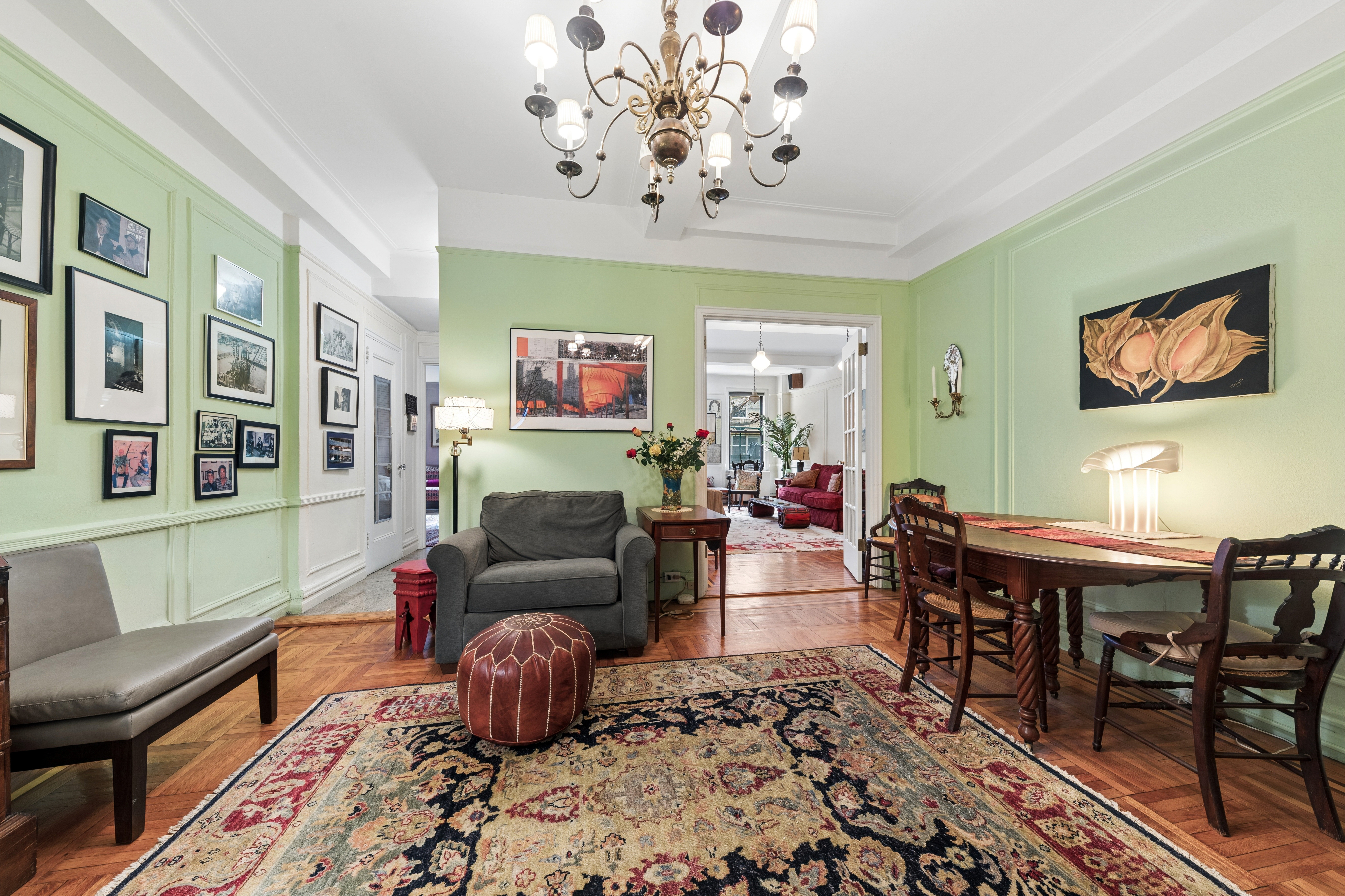 201 West 89th Street, Unit 1E Manhattan, NY 10024 - Photo 2 of 12 a living room with furniture and a chandelier
