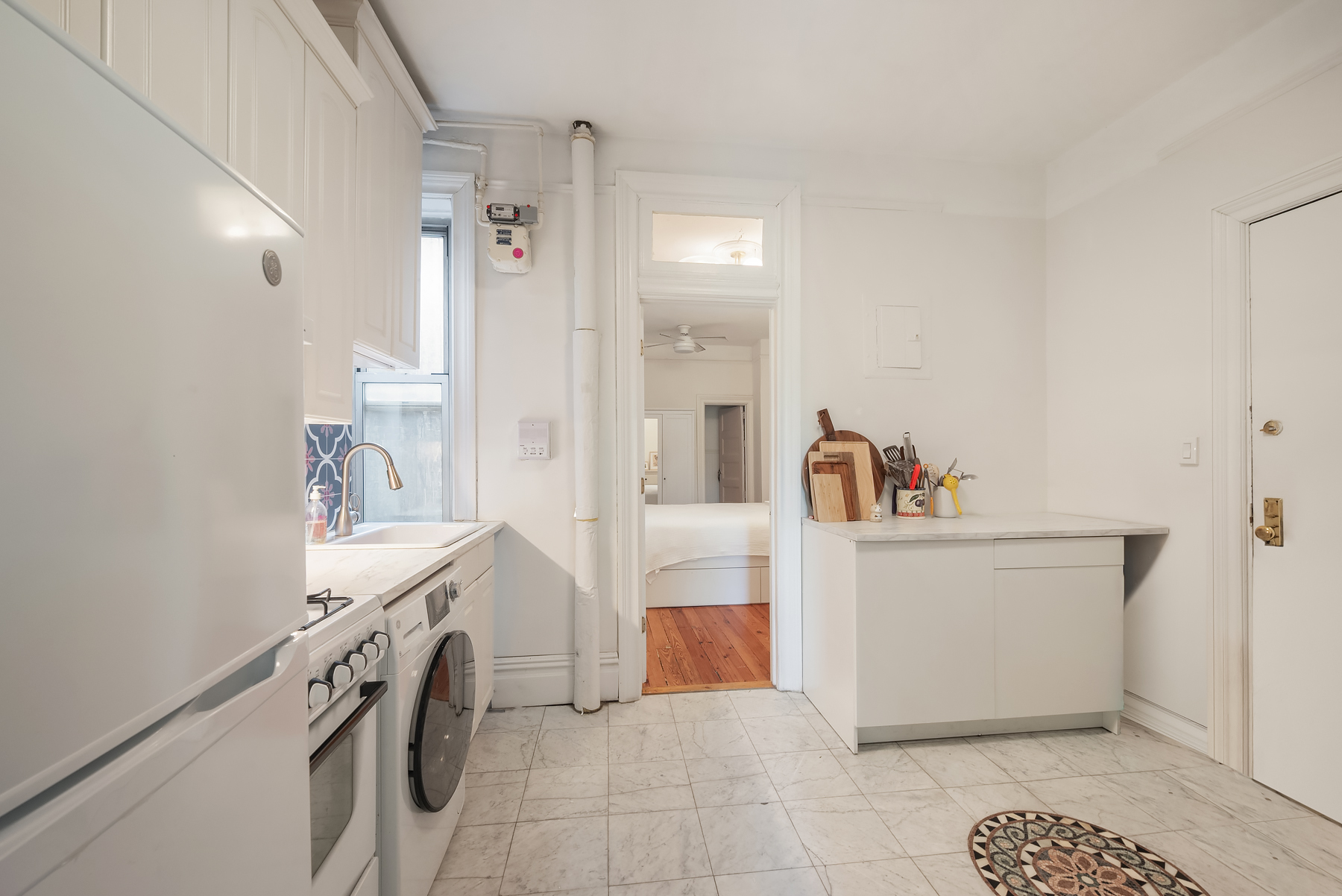 84 Charles Street, Unit 13 Manhattan, NY 10014 - Photo 5 of 8 a living room with a sink and a refrigerator
