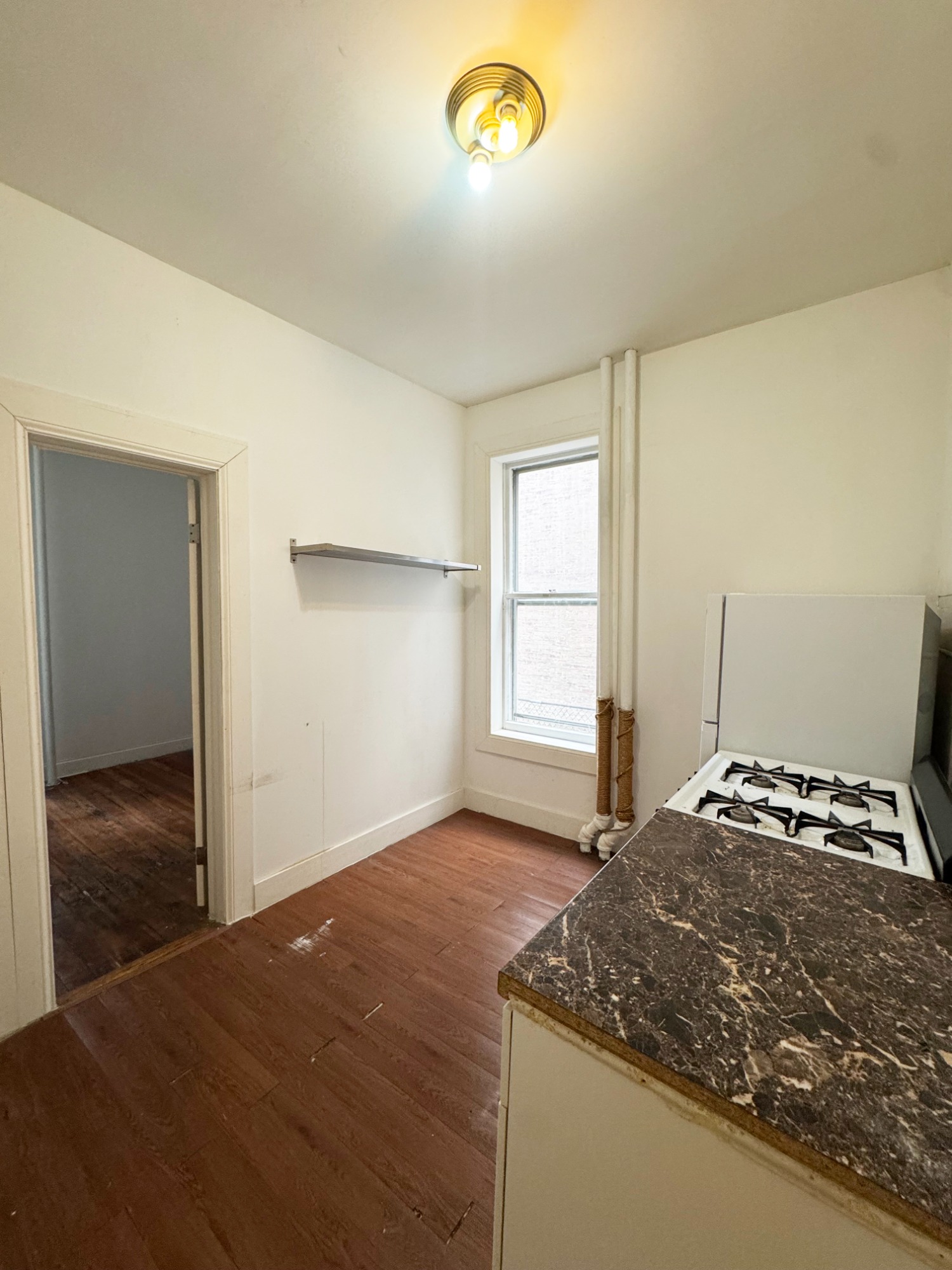 562 7th Street, Unit 3 Brooklyn, NY 11215 - Photo 2 of 6 a bedroom with a bed and a window